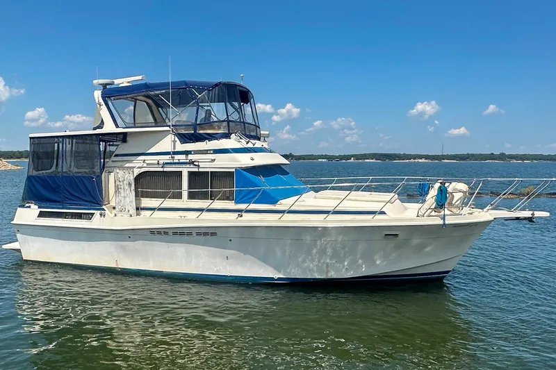Slide: The Image of 1985 Chris-Craft 426 Catalina yacht on calm water under clear blue sky. - 5