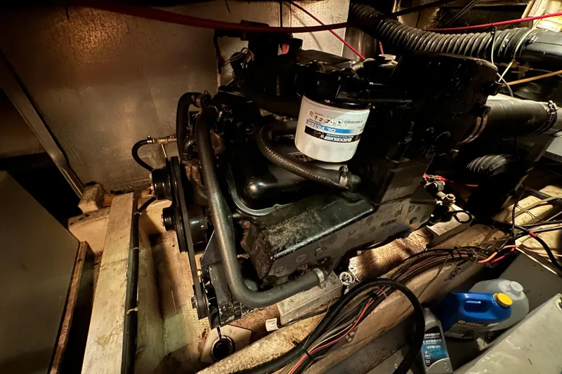 Slide: The Image of Engine compartment of 1985 Chris-Craft 426 Catalina, showcasing mechanical components and wiring. - 50