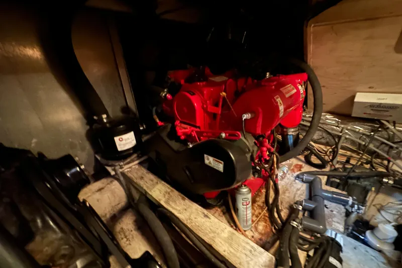 Slide: The Image of Engine room of 1985 Chris-Craft 426 Catalina with visible red engine components. - 51