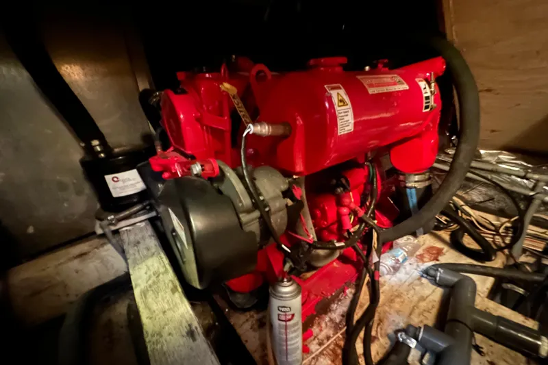 Slide: The Image of Engine room of 1985 Chris-Craft 426 Catalina with red machinery and hoses. - 52