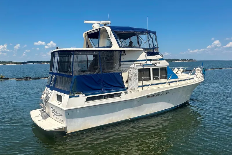 Slide: The Image of 1985 Chris-Craft 426 Catalina yacht on calm water under clear blue sky. - 6