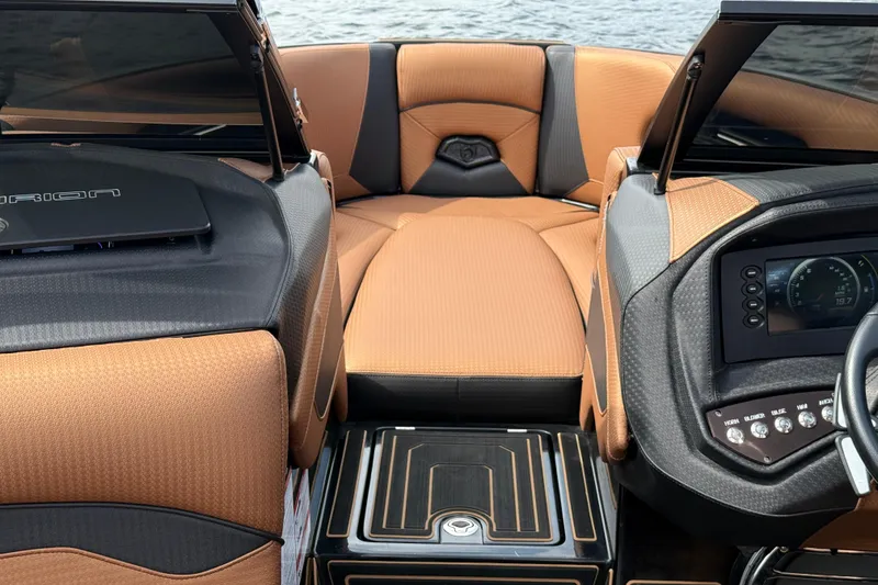 Slide: The Image of 2020 Centurion Ri257 boat interior with tan upholstery and modern dashboard controls. - 14
