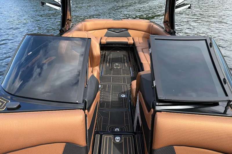 Slide: The Image of 2020 Centurion Ri257 boat interior with tan seating and sleek design on water. - 17