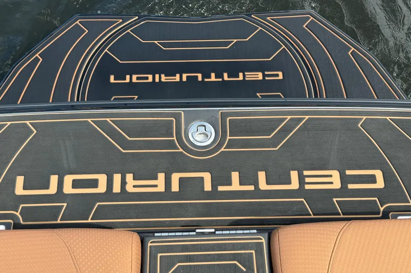 Slide: The Image of 2020 Centurion Ri257 boat deck with logo, featuring sleek black and orange design. - 19