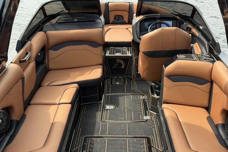 Slide: The Image of 2020 Centurion Ri257 boat interior with tan seating and modern dashboard design. - 20