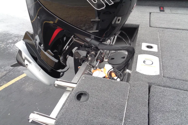 Slide: The Image of 2025 Lund 1875 Impact XS Sport boat engine and deck view. - 13