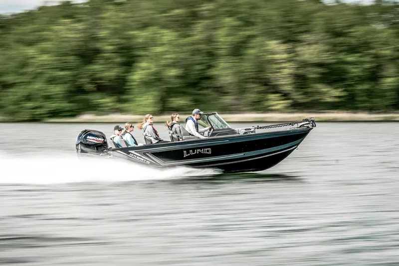 Slide: The Image of Manufacturer Provided Image: 2025 Lund 1875 Impact XS Sport boat speeding on a lake with passengers. - 16