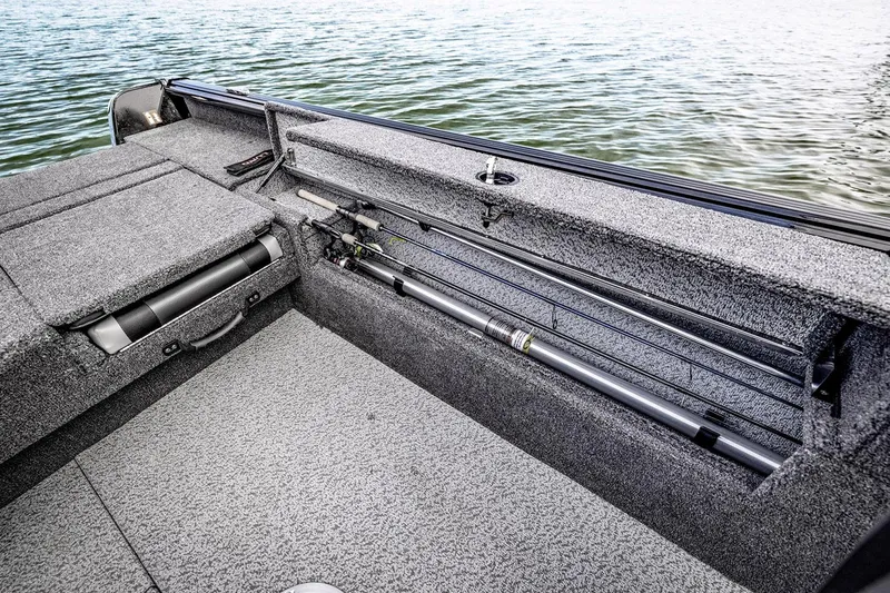 Slide: The Image of Manufacturer Provided Image: 2025 Lund 1875 Impact XS Sport boat interior with rod storage by the water. - 19