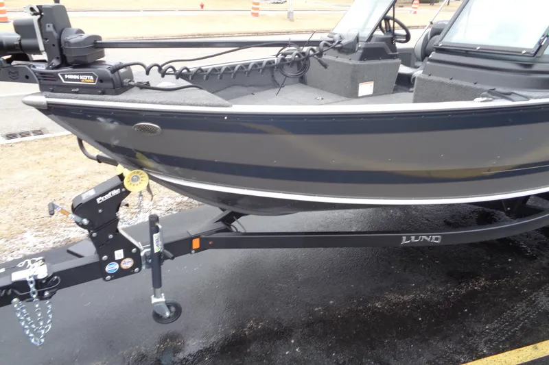 Slide: The Image of 2025 Lund 1875 Impact XS Sport boat on trailer, featuring sleek design and modern equipment. - 5