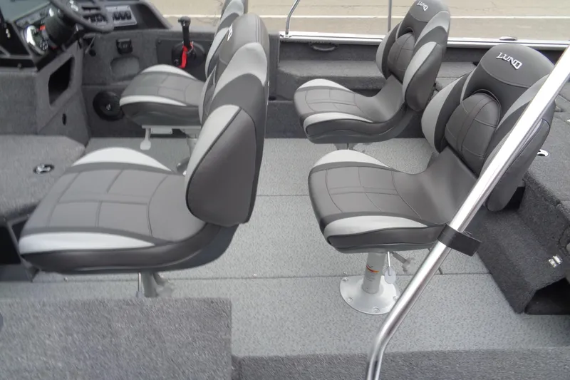 Slide: The Image of 2025 Lund 1875 Impact XS Sport boat interior with four gray seats. - 7