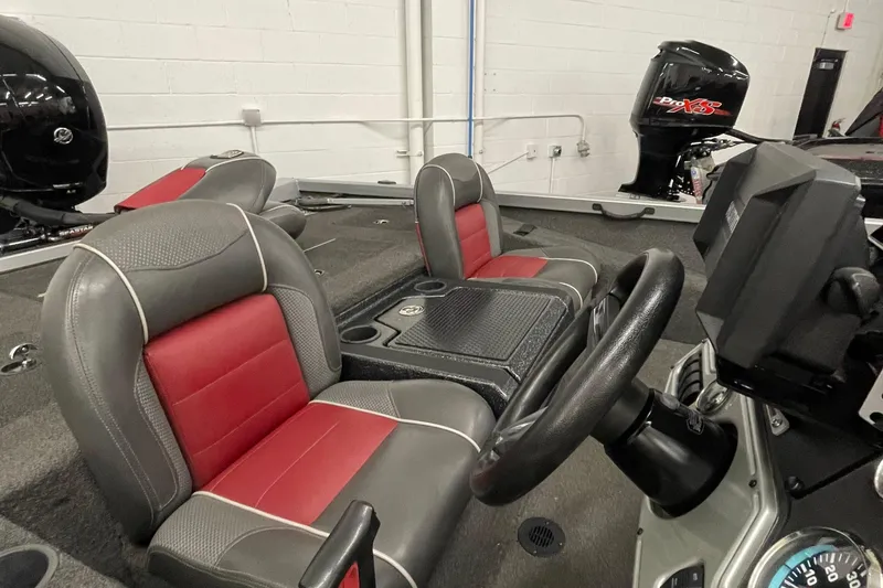 Slide: The Image of 2018 Ranger RT198P boat interior with red and gray seats, steering wheel, and console. - 3