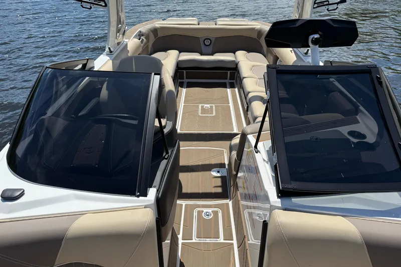 Slide: The Image of 2023 Centurion Fi25 boat interior with beige seating and sleek design on the water. - 12