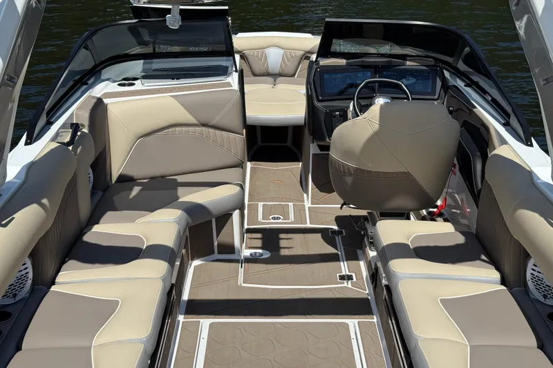 Slide: The Image of 2023 Centurion Fi25 boat interior with beige seating and modern dashboard design. - 15