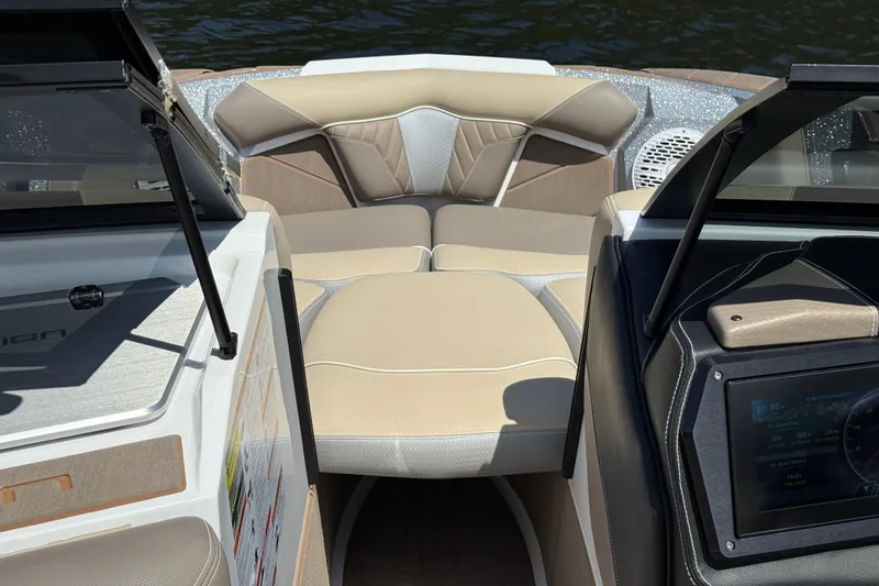 Slide: The Image of 2023 Centurion Fi25 boat interior with beige seating and modern dashboard. - 8