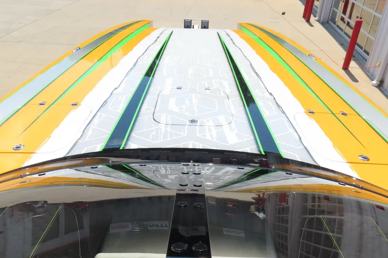 Slide: The Image of 2019 Wright Performance WP 360 boat with vibrant yellow and green accents on deck. - 18