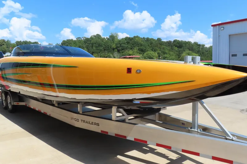 Slide: The Image of 2019 Wright Performance WP 360 boat with vibrant yellow and green design on trailer. - 3