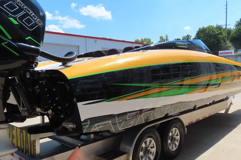 Slide: The Image of 2019 Wright Performance WP 360 speedboat with vibrant orange, green, and black design on a trailer. - 4