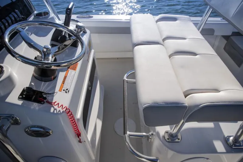 Slide: The Image of Manufacturer Provided Image: Parker 2100 Special Edition 2023 boat interior with steering wheel and cushioned seating. - 5