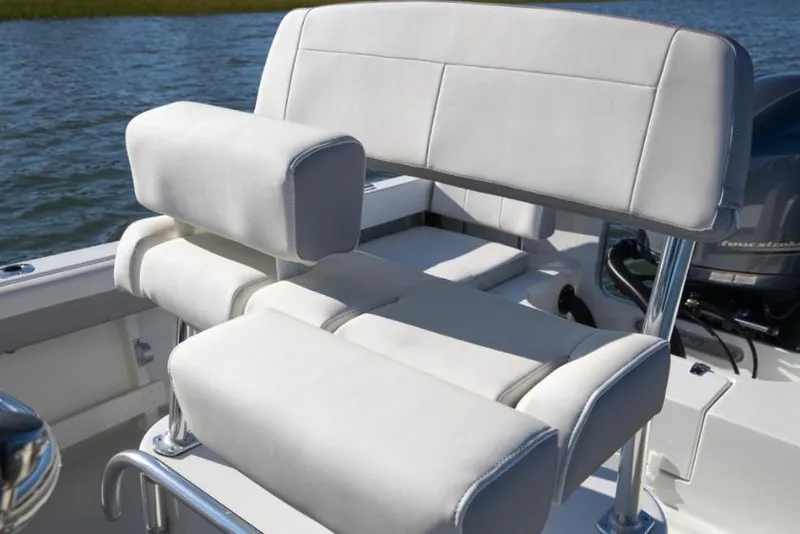 Slide: The Image of Manufacturer Provided Image: Parker 2100 Special Edition 2023 boat seating with white cushioned seats on water. - 6