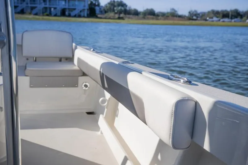 Slide: The Image of Manufacturer Provided Image: Parker 2100 Special Edition 2023 boat interior with cushioned seating by the water. - 7