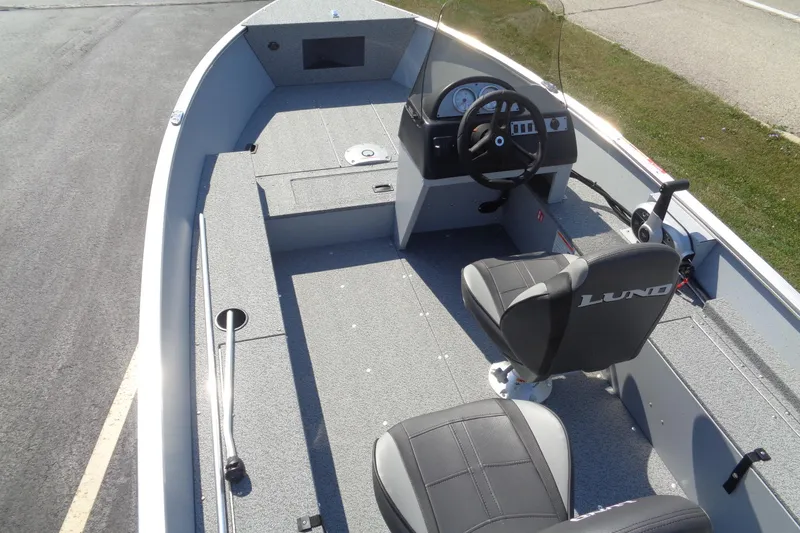 Slide: The Image of 2026 Lund 1600 Fury SS boat interior with steering console and seating. - 10