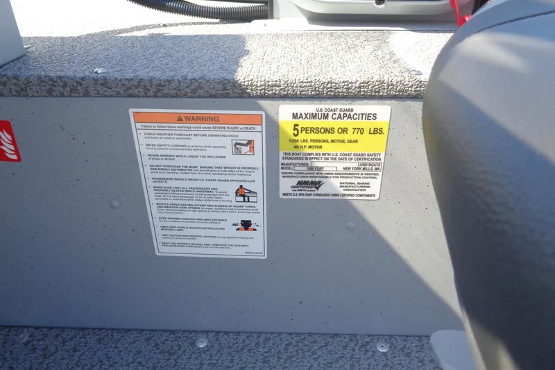 Slide: The Image of 2026 Lund 1600 Fury SS boat capacity warning label, maximum 5 persons or 770 lbs. - 12