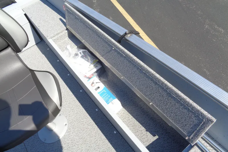 Slide: The Image of 2026 Lund 1600 Fury SS boat interior with storage compartment and seat. - 19