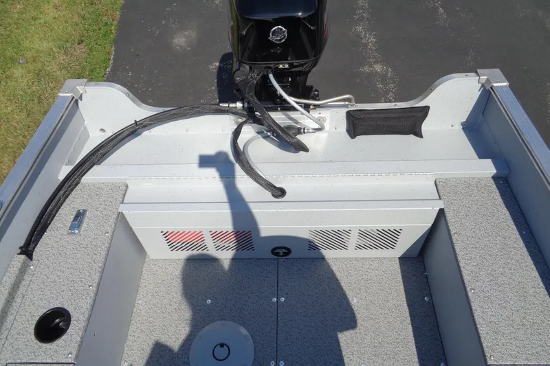 Slide: The Image of 2026 Lund 1600 Fury SS boat interior with motor and storage compartments. - 20