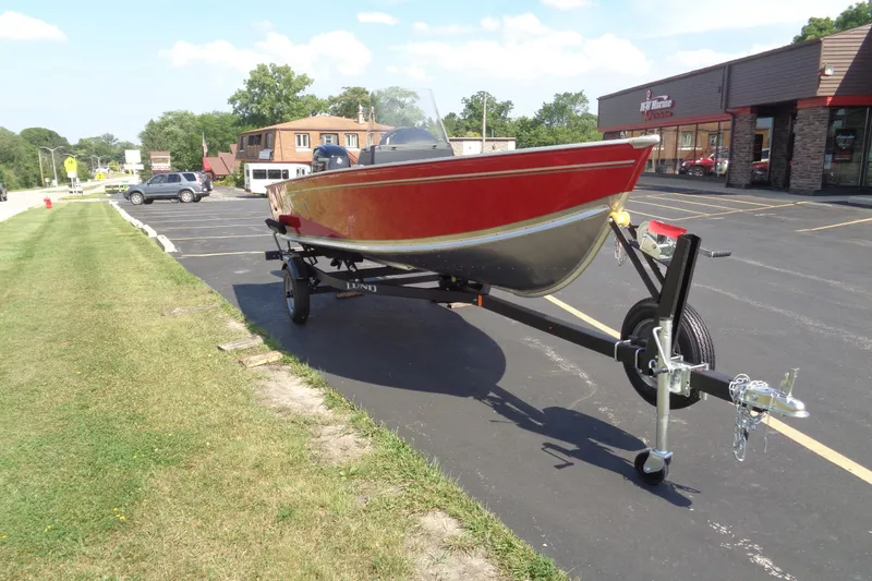 Slide: The Image of 2026 Lund 1600 Fury SS boat on trailer in parking lot, sunny day. - 8