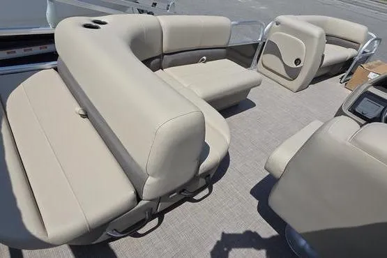 Slide: The Image of 2025 Sun Tracker PB 18 DLX pontoon boat interior with beige seating and spacious layout. - 11