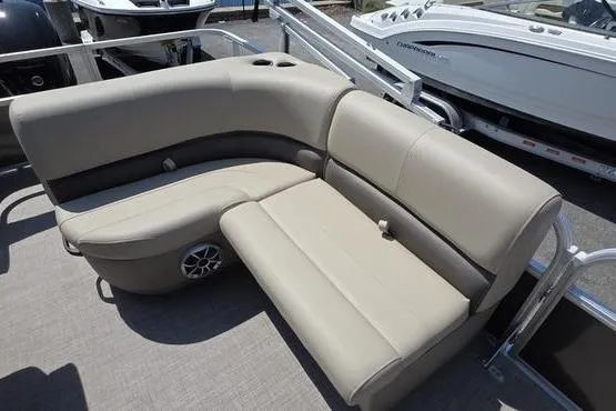 Slide: The Image of 2025 Sun Tracker PB 18 DLX pontoon boat with beige seating and speaker system. - 7