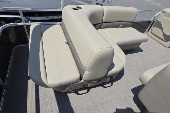 Slide: The Image of 2025 Sun Tracker PB 18 DLX pontoon boat interior with beige seating and cup holders. - 9