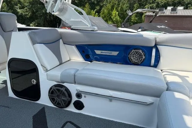 Slide: The Image of 2016 MasterCraft X26 boat interior with gray seating and audio system. - 18