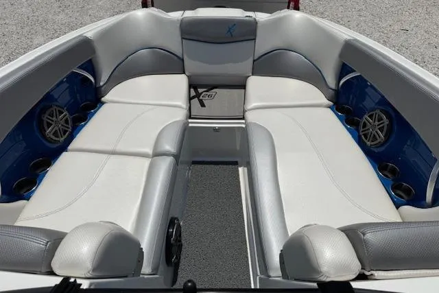 Slide: The Image of 2016 MasterCraft X26 boat interior with white seating and blue accents. - 19