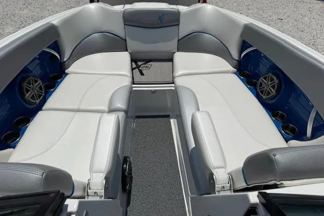Slide: The Image of 2016 MasterCraft X26 boat interior with white seating and blue accents. - 22