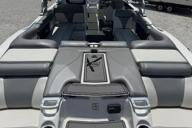Slide: The Image of 2016 MasterCraft X26 boat interior with gray and white seating, showcasing luxury design. - 3