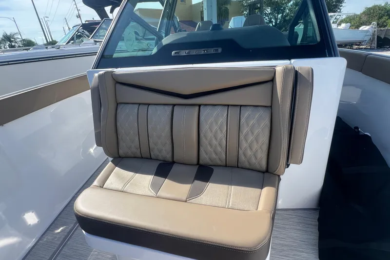 Slide: The Image of 2026 Monterey Elite 27 OB boat seat with beige and gray upholstery, featuring diamond stitching. - 12