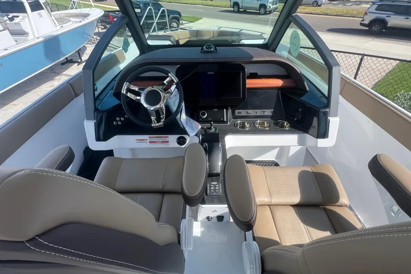 Slide: The Image of 2026 Monterey Elite 27 OB boat interior with modern dashboard and comfortable seating. - 17
