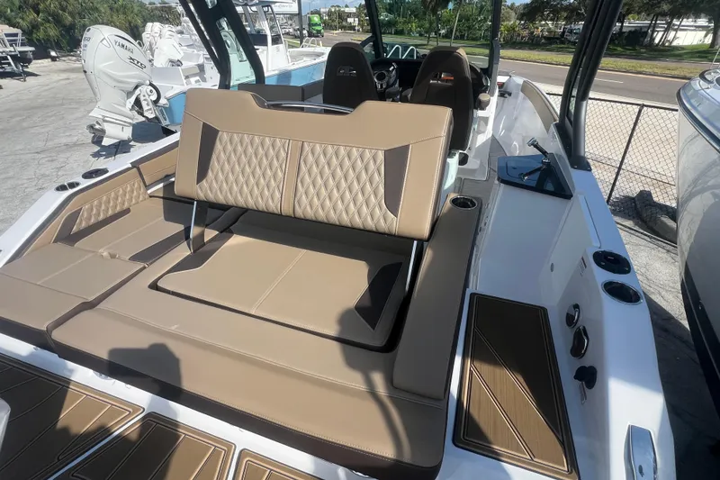 Slide: The Image of 2026 Monterey Elite 27 OB boat interior with tan seating and modern design. - 18