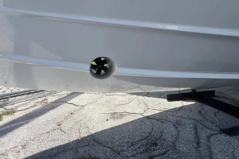 Slide: The Image of 2026 Monterey Elite 27 OB boat hull with visible thruster on a trailer. - 2