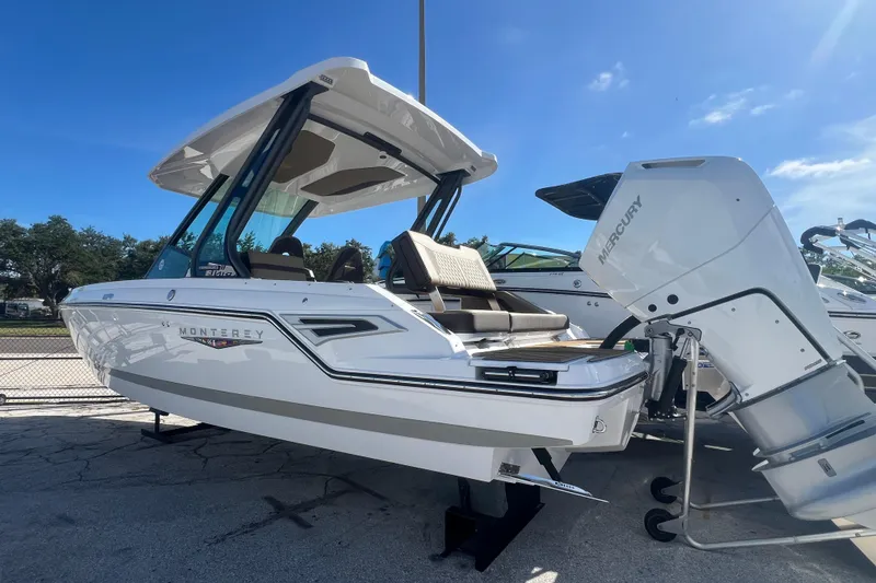 Slide: The Image of 2026 Monterey Elite 27 OB boat with Mercury outboard engine, displayed outdoors. - 22