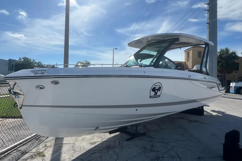 Slide: The Image of 2026 Monterey Elite 27 OB boat displayed outdoors under a clear blue sky. - 24