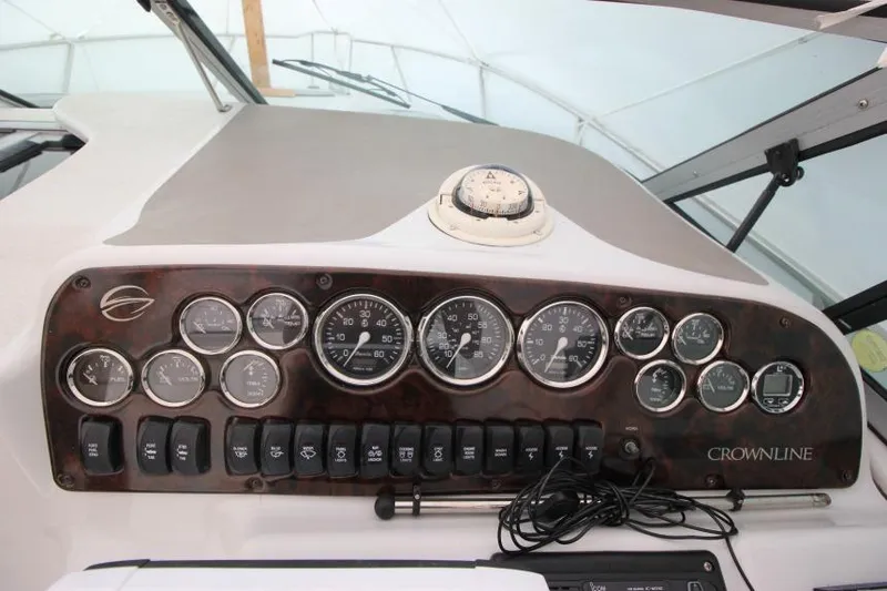 Slide: The Image of Dashboard of a 2002 Crownline 290 CR boat with gauges and controls. - 10