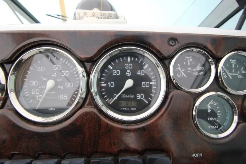 Slide: The Image of Dashboard of a 2002 Crownline 290 CR boat with speedometer and gauges. - 11