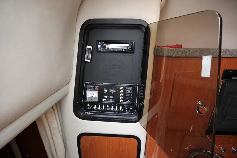 Slide: The Image of Control panel inside a 2002 Crownline 290 CR boat cabin. - 17