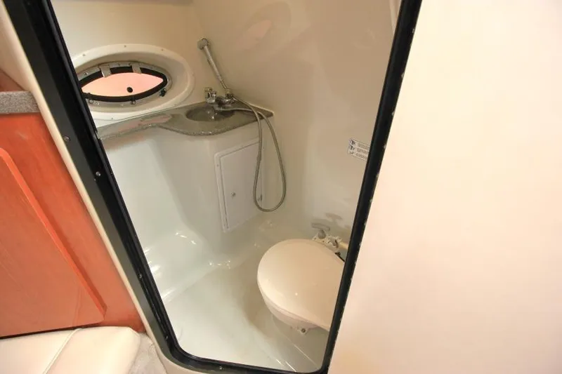 Slide: The Image of Bathroom interior of 2002 Crownline 290 CR boat with sink and toilet. - 19