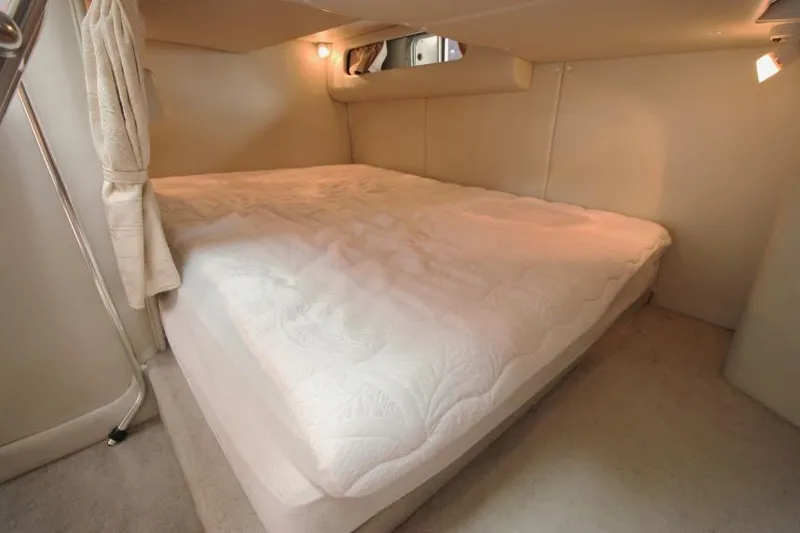 Slide: The Image of Interior cabin of 2002 Crownline 290 CR with cozy bed and soft lighting. - 20