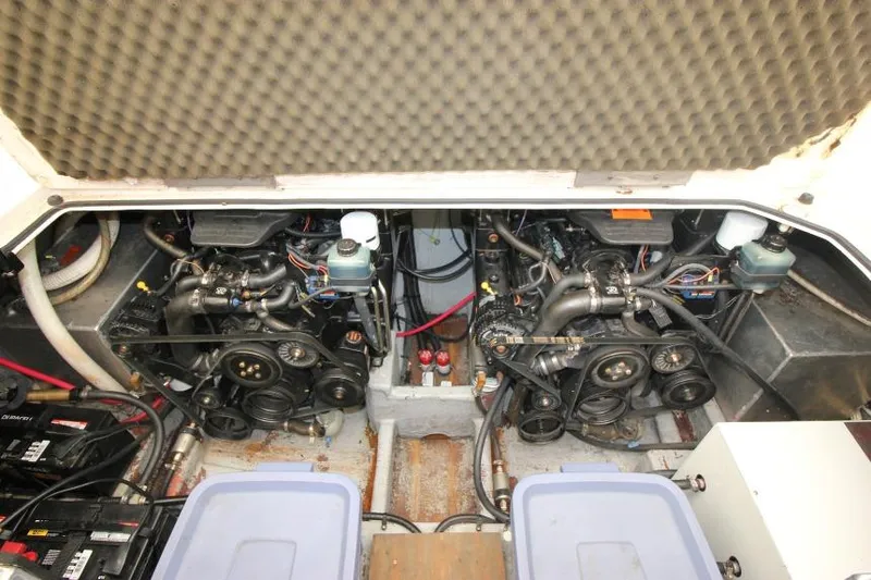 Slide: The Image of Engine compartment of a 2002 Crownline 290 CR boat, showcasing dual engines and components. - 22