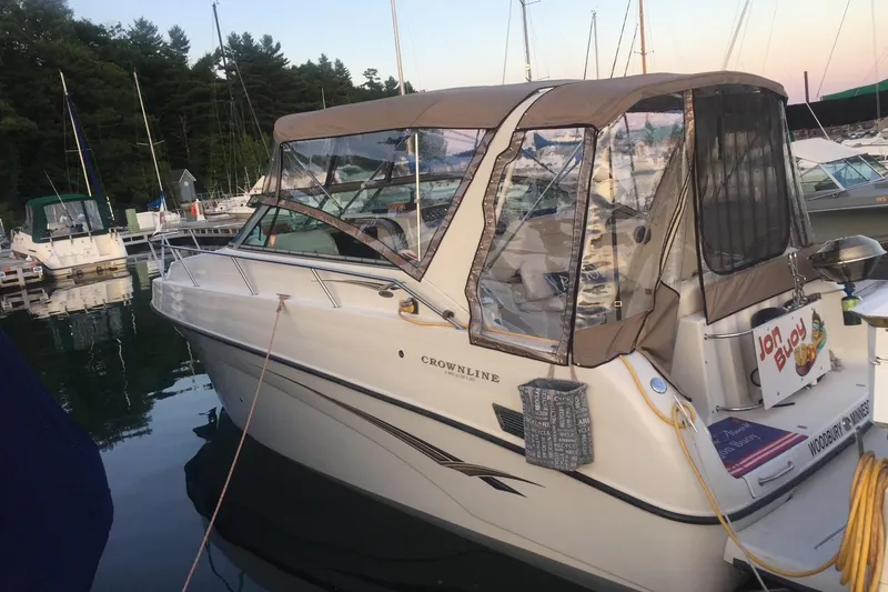 Slide: The Image of 2002 Crownline 290 CR boat docked at marina with canopy and clear windows. - 25