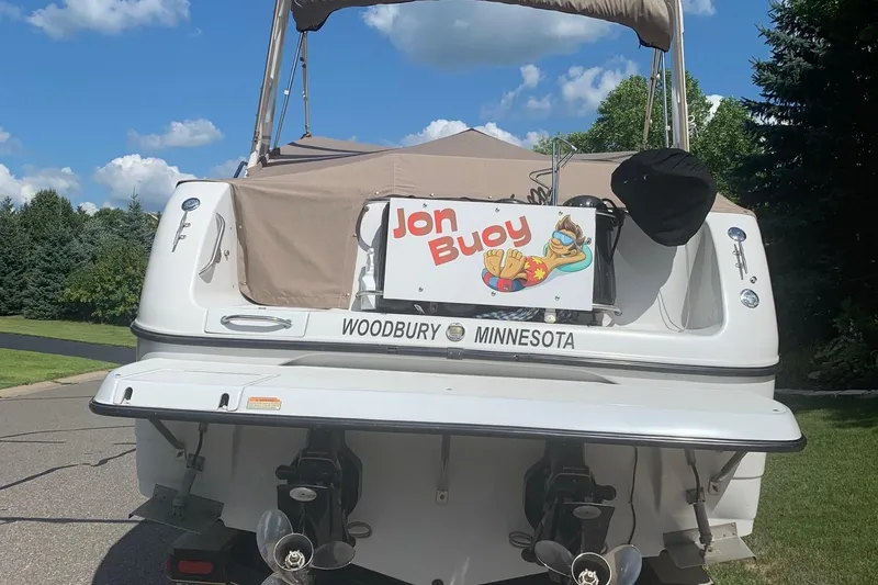 Slide: The Image of 2002 Crownline 290 CR boat with "Jon Buoy" sign, parked in Woodbury, Minnesota. - 26